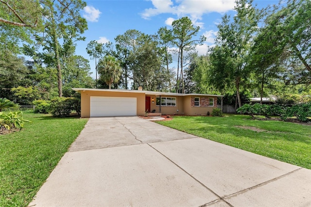3857 SW 4th Pl, Gainesville, FL 32607 - ranch-style home with driveway, an attached garage, and stucco siding