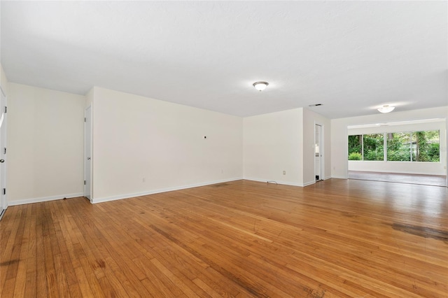 3857 SW 4th Pl, Gainesville, FL 32607 - unfurnished living room featuring light wood-style flooring and baseboards