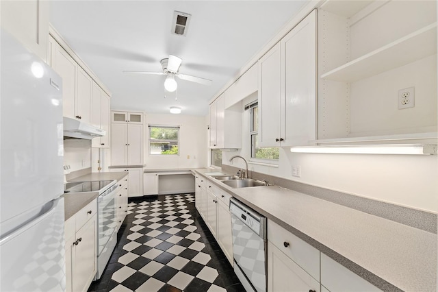 3857 SW 4th Pl, Gainesville, FL 32607 - kitchen with white appliances, under cabinet range hood, white cabinetry, and a ceiling fan