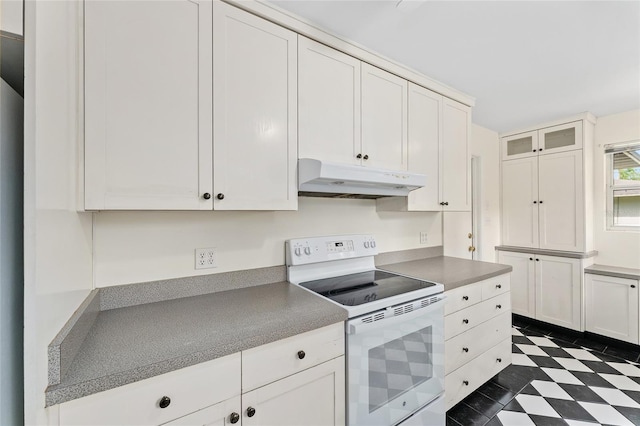 3857 SW 4th Pl, Gainesville, FL 32607 - kitchen with white range with electric cooktop, under cabinet range hood, white cabinetry, and glass insert cabinets