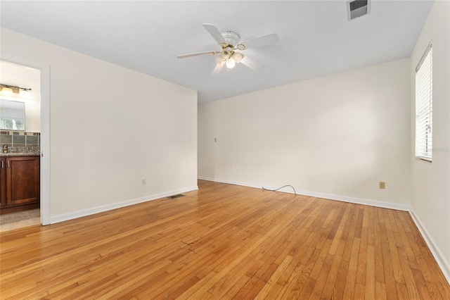 3857 SW 4th Pl, Gainesville, FL 32607 - empty room featuring ceiling fan, light wood-style floors, and plenty of natural light