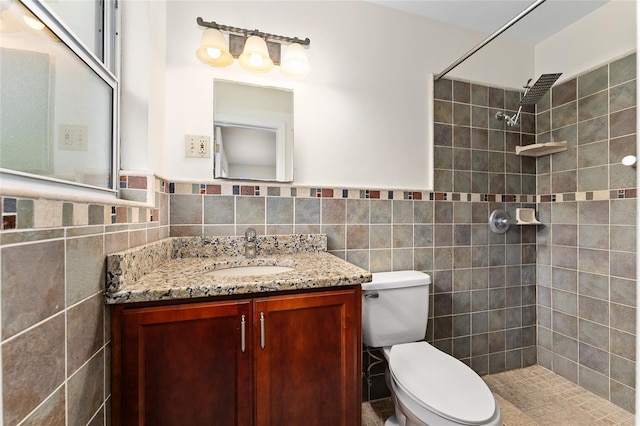 3857 SW 4th Pl, Gainesville, FL 32607 - full bath with tile walls, a tile shower, vanity, and a wainscoted wall