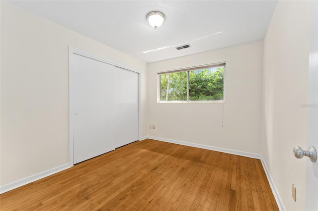 3857 SW 4th Pl, Gainesville, FL 32607 - unfurnished bedroom featuring light wood finished floors and a closet