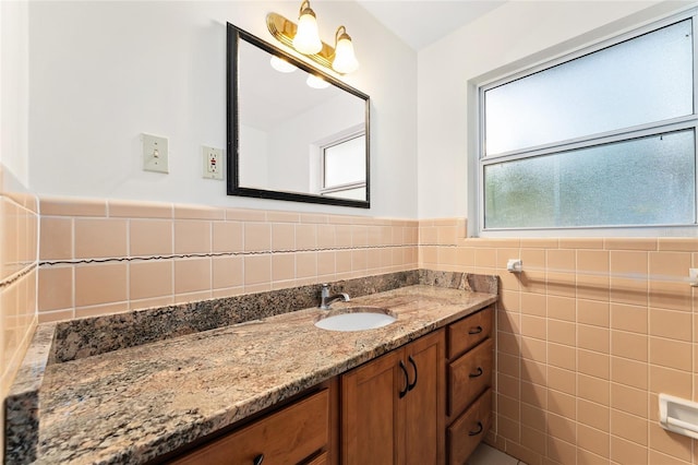 3857 SW 4th Pl, Gainesville, FL 32607 - bathroom featuring vanity, tile walls, and a wainscoted wall