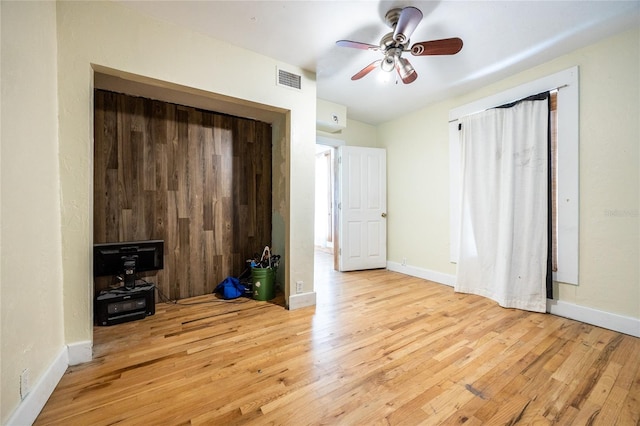 407 NW 8th St, Gainesville, FL 32601 - unfurnished living room with wood finished floors and ceiling fan