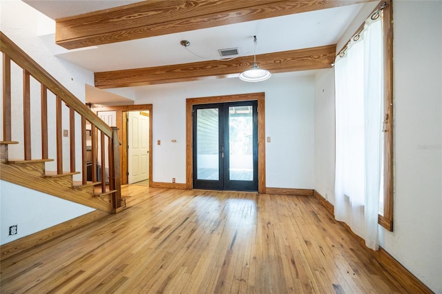 407 NW 8th St, Gainesville, FL 32601 - entryway featuring french doors, light wood finished floors, stairway, and beam ceiling