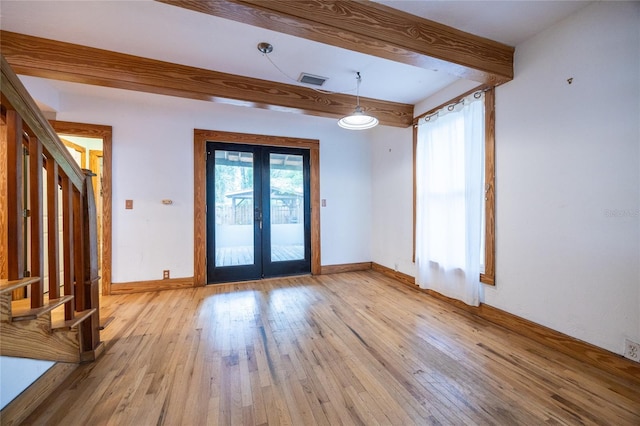 407 NW 8th St, Gainesville, FL 32601 - empty room featuring french doors, stairs, beamed ceiling, and light wood finished floors