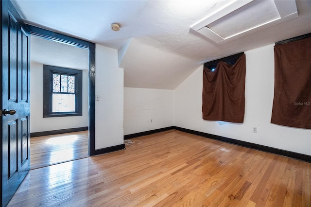 407 NW 8th St, Gainesville, FL 32601 - bonus room with attic access, light wood finished floors, and lofted ceiling