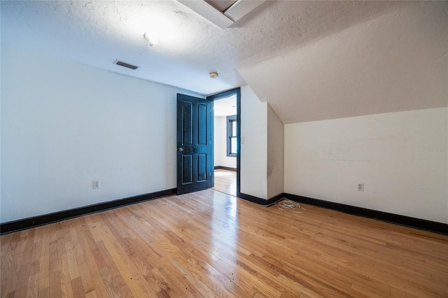 407 NW 8th St, Gainesville, FL 32601 - bonus room with a textured ceiling, light wood-style flooring, and lofted ceiling