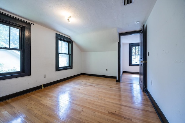 407 NW 8th St, Gainesville, FL 32601 - additional living space with light wood-style floors and lofted ceiling