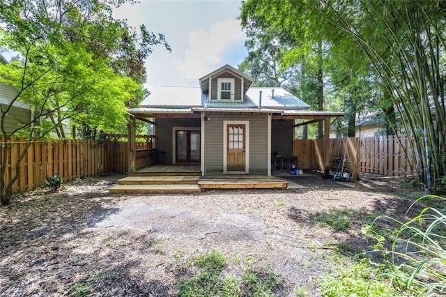 407 NW 8th St, Gainesville, FL 32601 - back of house featuring a fenced backyard, a metal roof, and a wooden deck