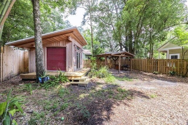 407 NW 8th St, Gainesville, FL 32601 - fenced backyard with a deck and an outbuilding