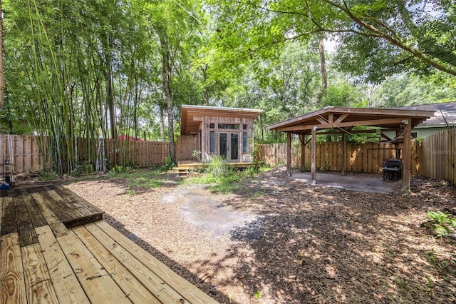 407 NW 8th St, Gainesville, FL 32601 - deck featuring a fenced backyard, a gazebo, a detached carport, french doors, and grilling area