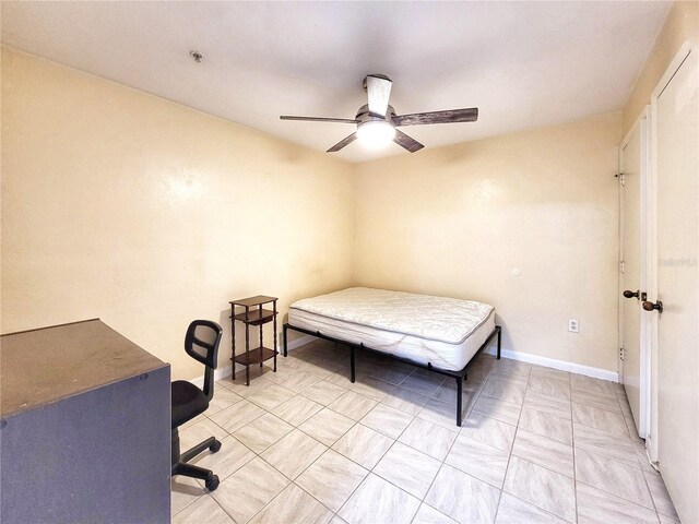 4000 SW 23rd St Unit 2-104, Gainesville, FL 32608 - bedroom featuring baseboards and a ceiling fan
