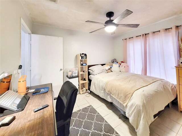 4000 SW 23rd St Unit 2-104, Gainesville, FL 32608 - bedroom featuring light tile patterned floors and a ceiling fan