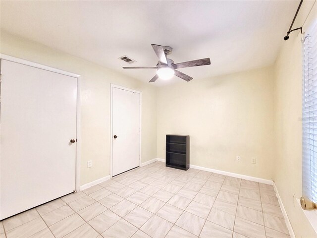 4000 SW 23rd St Unit 2-104, Gainesville, FL 32608 - unfurnished bedroom featuring baseboards and a ceiling fan
