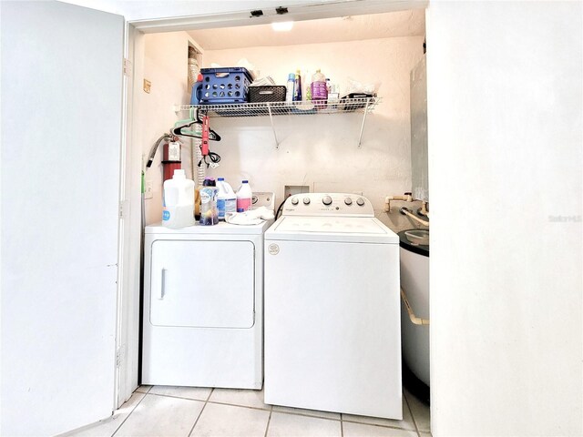 4000 SW 23rd St Unit 2-104, Gainesville, FL 32608 - washroom with separate washer and dryer and light tile patterned flooring