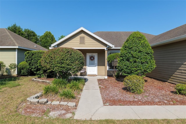 7547 SW 87th Ter, Gainesville, FL 32608 - view of front facade with a front lawn and a shingled roof
