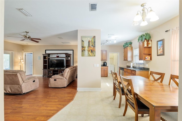 7547 SW 87th Ter, Gainesville, FL 32608 - dining area featuring healthy amount of natural light, a chandelier, a ceiling fan, and washer / dryer