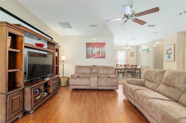 7547 SW 87th Ter, Gainesville, FL 32608 - living area with wood finished floors, a ceiling fan, and a chandelier