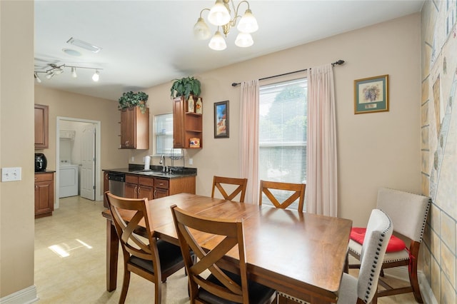 7547 SW 87th Ter, Gainesville, FL 32608 - dining room with washer / clothes dryer, light flooring, and a chandelier
