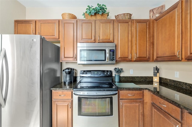 7547 SW 87th Ter, Gainesville, FL 32608 - kitchen with appliances with stainless steel finishes, brown cabinetry, and dark stone countertops