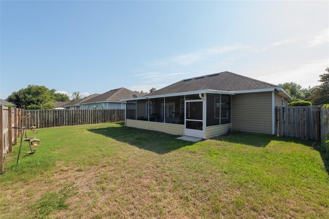 7547 SW 87th Ter, Gainesville, FL 32608 - fenced backyard featuring a sunroom