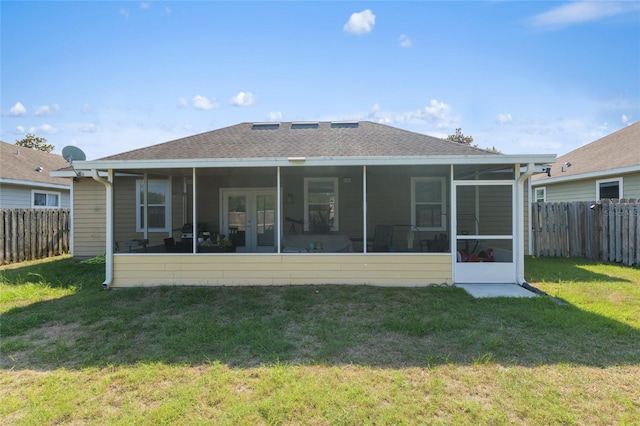 7547 SW 87th Ter, Gainesville, FL 32608 - rear view of house featuring a sunroom, a fenced backyard, and a shingled roof