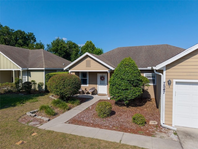 7547 SW 87th Ter, Gainesville, FL 32608 - single story home with a front lawn, a garage, and roof with shingles