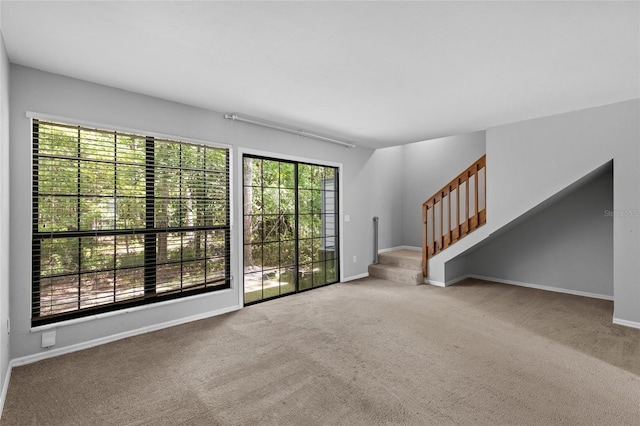 7074 NW 52nd Ter, Gainesville, FL 32653 - unfurnished living room featuring plenty of natural light, carpet, and stairs