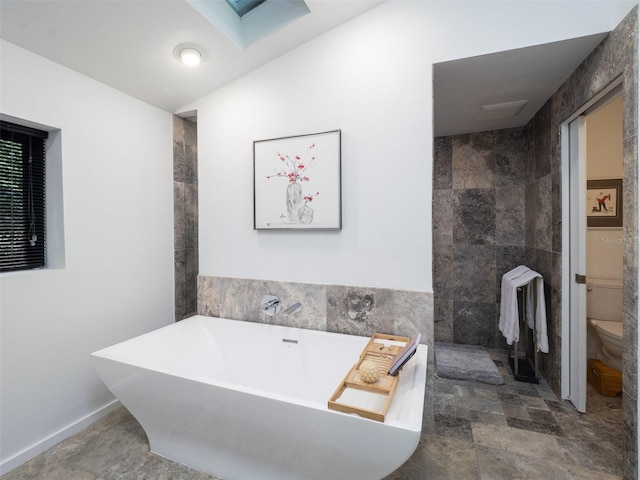 2261 NW 24th Ave, Gainesville, FL 32605 - bathroom featuring a freestanding tub, a walk in shower, and tile walls