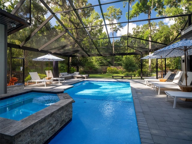 2261 NW 24th Ave, Gainesville, FL 32605 - view of pool featuring a patio, glass enclosure, and a pool with connected hot tub