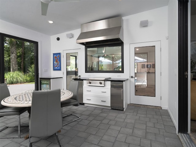 2261 NW 24th Ave, Gainesville, FL 32605 - dining room with brick patterned floors, a ceiling fan, wine cooler, and recessed lighting