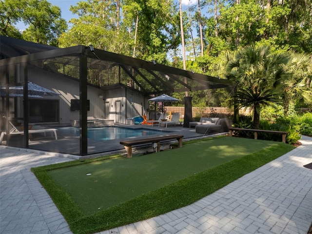 2261 NW 24th Ave, Gainesville, FL 32605 - view of yard featuring a putting area, a patio area, an outdoor hangout area, and a pool with connected hot tub