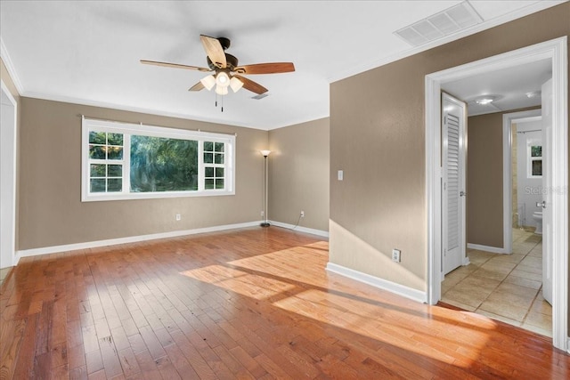 3404 NW 4th St, Gainesville, FL 32609 - empty room with ceiling fan, wood-type flooring, and crown molding