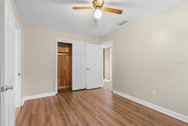 3404 NW 4th St, Gainesville, FL 32609 - unfurnished bedroom with a closet, wood finished floors, and a ceiling fan