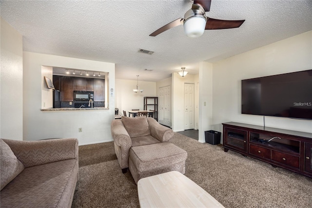 3705 SW 27th St Unit 525, Gainesville, FL 32608 - carpeted living room featuring a ceiling fan and a textured ceiling