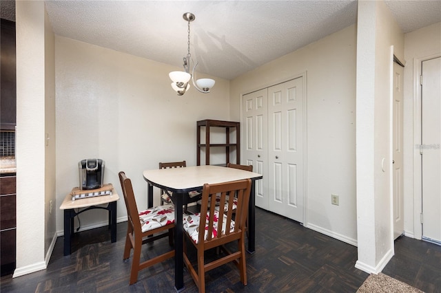 3705 SW 27th St Unit 525, Gainesville, FL 32608 - dining space featuring a chandelier and a textured ceiling