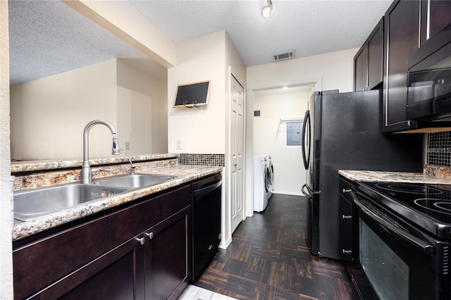 3705 SW 27th St Unit 525, Gainesville, FL 32608 - kitchen featuring washer and clothes dryer, black appliances, a textured ceiling, light countertops, and dark brown cabinetry