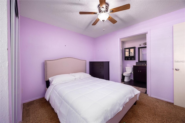 3705 SW 27th St Unit 525, Gainesville, FL 32608 - carpeted bedroom featuring a textured ceiling, ensuite bath, and a ceiling fan