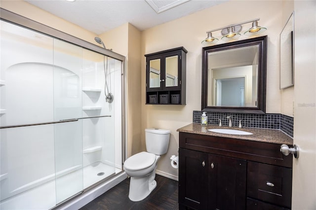 3705 SW 27th St Unit 525, Gainesville, FL 32608 - full bath with a shower stall, backsplash, vanity, and wood finished floors
