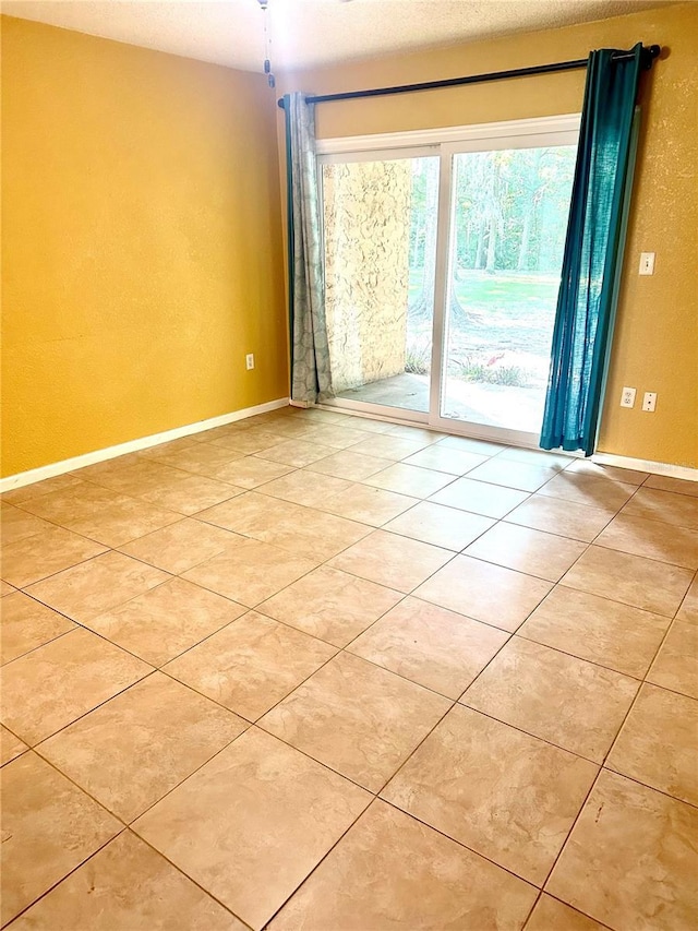 1810 NW 23rd Blvd Unit 272, Gainesville, FL 32605 - spare room featuring light tile patterned flooring and baseboards
