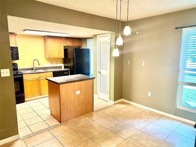 1810 NW 23rd Blvd Unit 272, Gainesville, FL 32605 - kitchen with black appliances, a textured ceiling, a center island, light tile patterned floors, and plenty of natural light