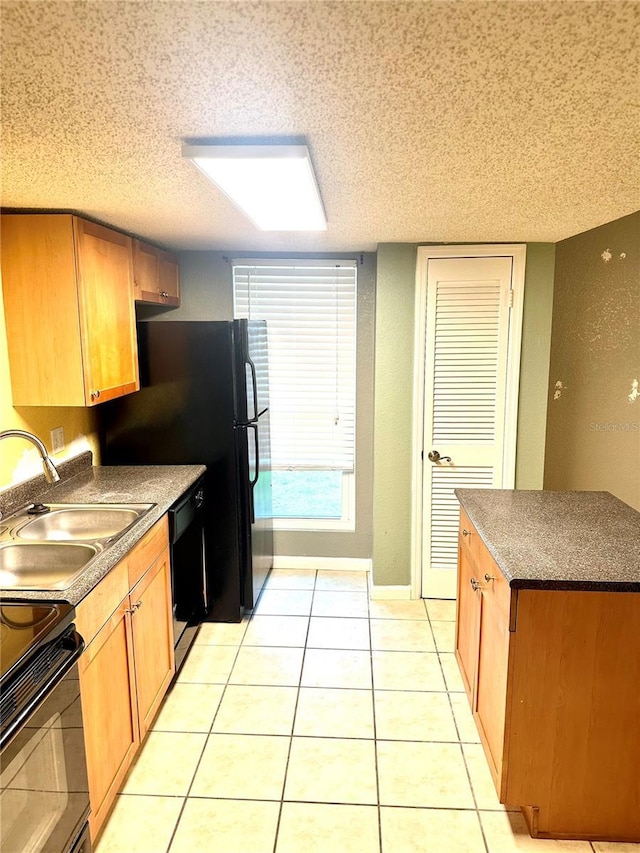 1810 NW 23rd Blvd Unit 272, Gainesville, FL 32605 - kitchen with black appliances, a textured ceiling, light tile patterned floors, and dark countertops
