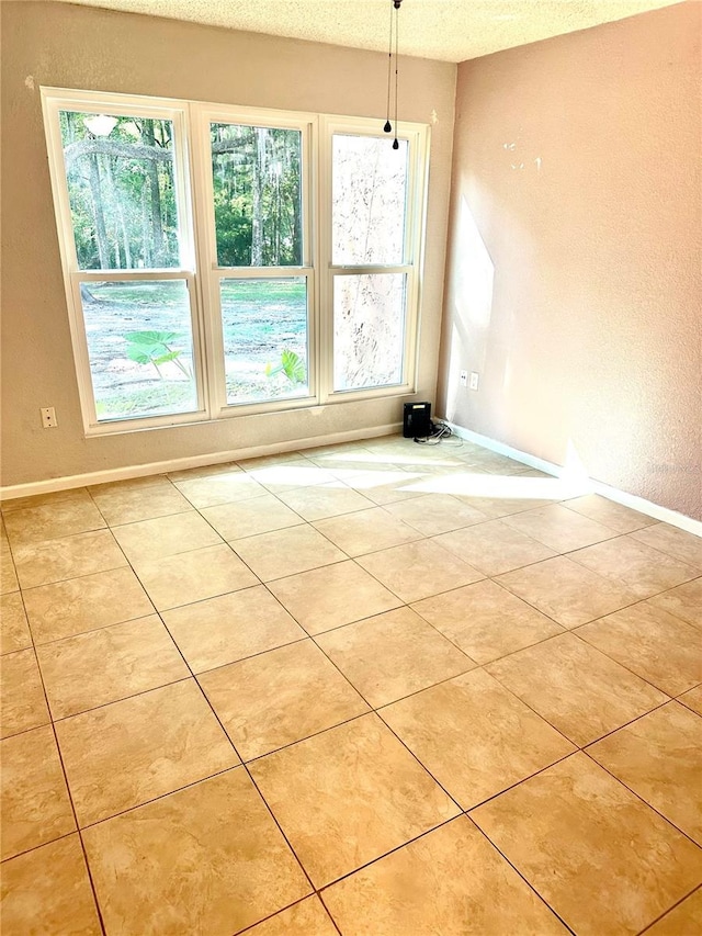 1810 NW 23rd Blvd Unit 272, Gainesville, FL 32605 - unfurnished dining area featuring tile patterned flooring, a textured ceiling, and a textured wall