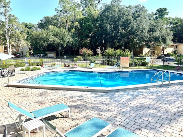 1810 NW 23rd Blvd Unit 272, Gainesville, FL 32605 - community pool with a patio and view of wooded area