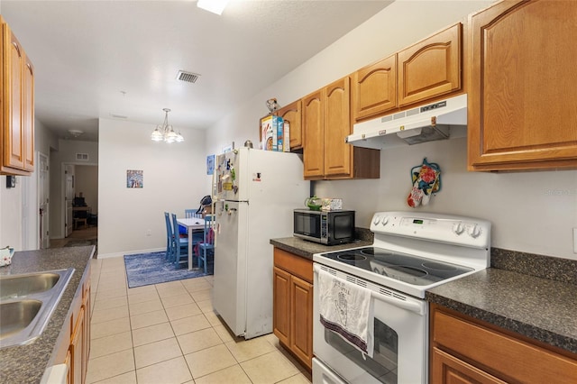 1573 NW 29th Rd Unit 3, Gainesville, FL 32605 - kitchen with white appliances, under cabinet range hood, dark countertops, a chandelier, and light tile patterned flooring