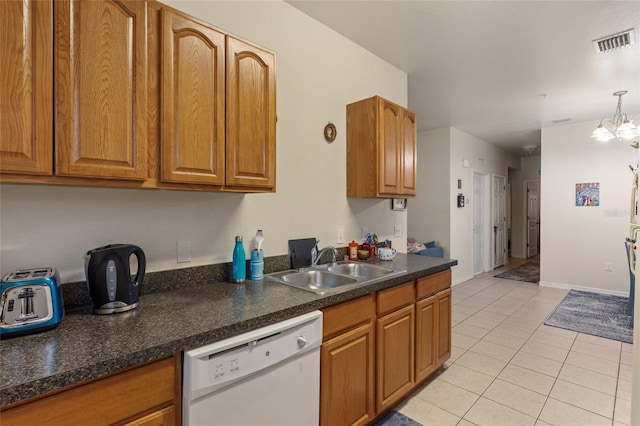 1573 NW 29th Rd Unit 3, Gainesville, FL 32605 - kitchen featuring white dishwasher, light tile patterned floors, brown cabinetry, and dark countertops