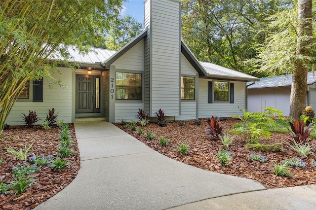 2101 SW 79th Dr, Gainesville, FL 32607 - view of front of property with a metal roof, a chimney, and a standing seam roof