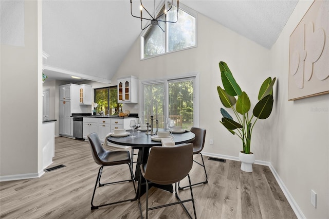 2101 SW 79th Dr, Gainesville, FL 32607 - dining space featuring high vaulted ceiling, a chandelier, and light wood-style floors